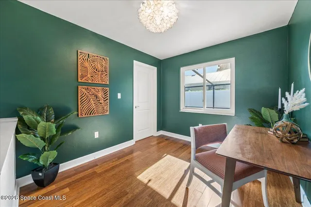 a living room with furniture a rug and white walls
