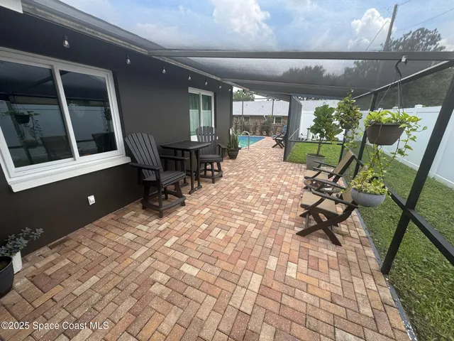 an aerial view of a house with yard