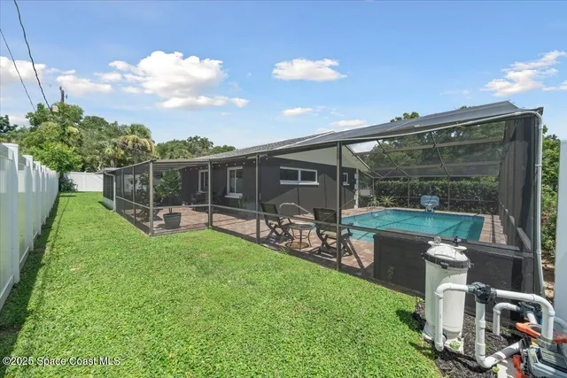 a dining room with furniture and a floor to ceiling window