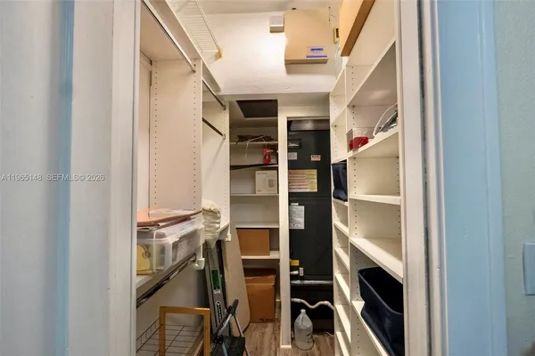 a view of walk in closet with empty racks