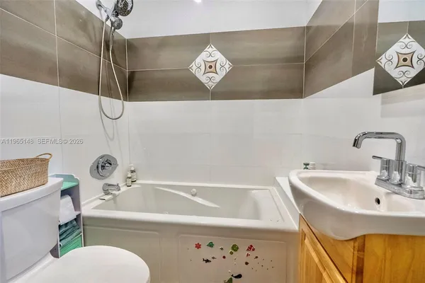 a bathroom with a sink a toilet and a bathtub
