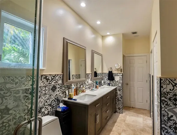 a bathroom with a sink double vanity and a mirror