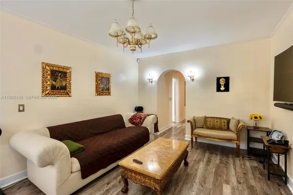 a living room with furniture and a chandelier