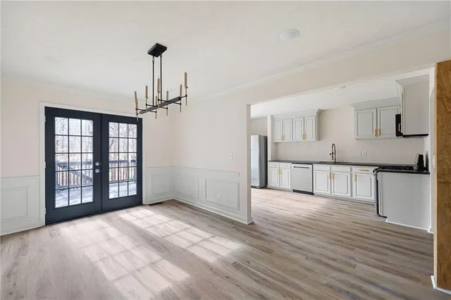 a view of a kitchen with wooden floor and a kitchen