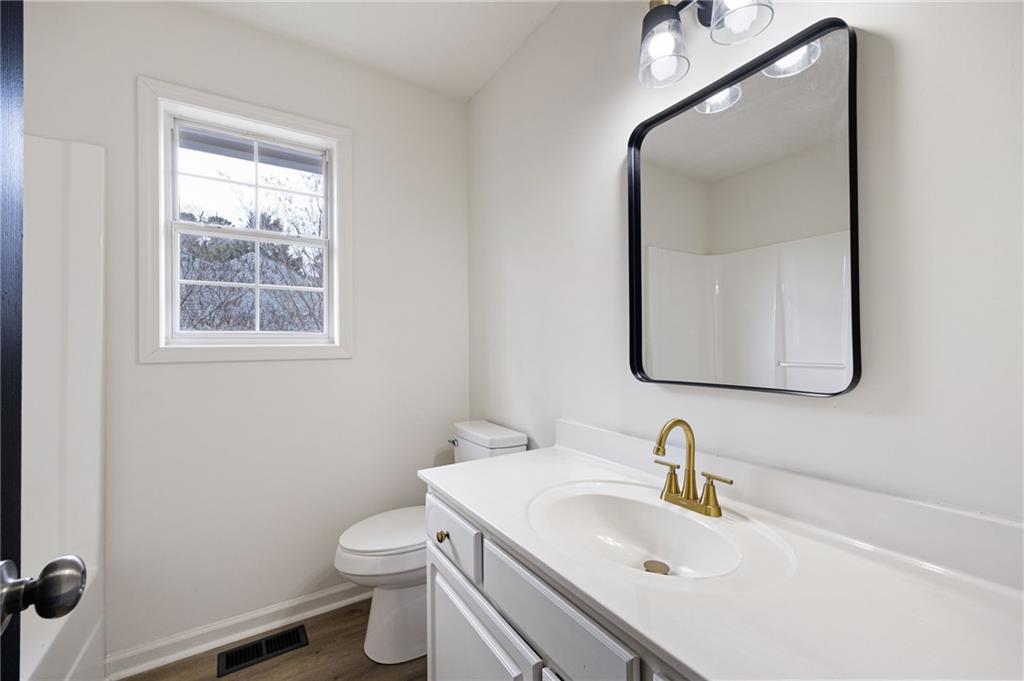 1029 Regency Drive Acworth, GA 30102 - Photo 21 of 36 a bathroom with a toilet sink and mirror