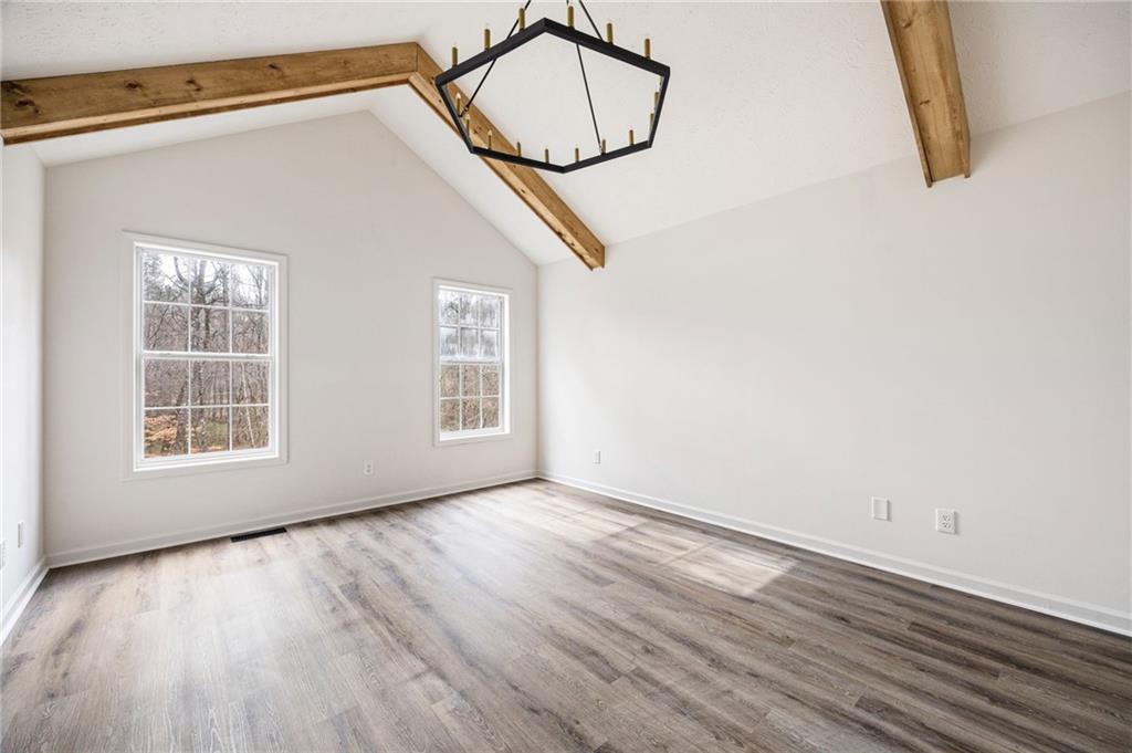 1029 Regency Drive Acworth, GA 30102 - Photo 23 of 36 an empty room with wooden floor and windows