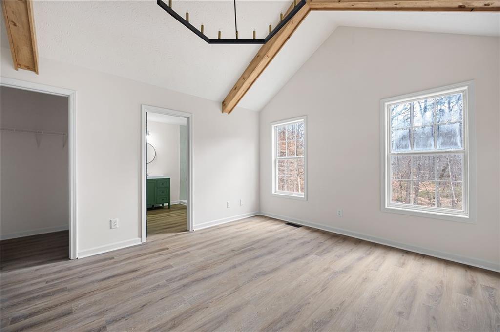 1029 Regency Drive Acworth, GA 30102 - Photo 24 of 36 a view of an empty room with wooden floor and a window