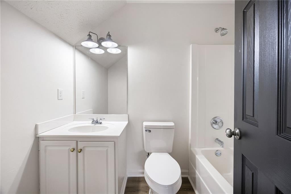 1029 Regency Drive Acworth, GA 30102 - Photo 30 of 36 a bathroom with a toilet sink mirror and vanity