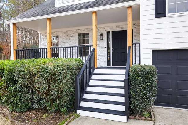 a view of a house with a flower garden