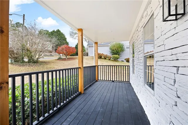 a view of a balcony with wooden floor
