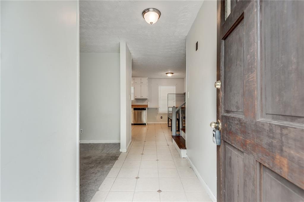 5611 Whittondale Road Lithonia, GA 30058 - Photo 2 of 34 a view of a hallway with a dining table chair