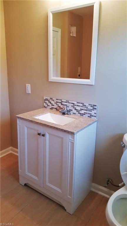 8131 East Harrell Road Oak Ridge, NC 27310 - Photo 12 of 13 Hall bath with new vanity, fixtures, and tile flooring!