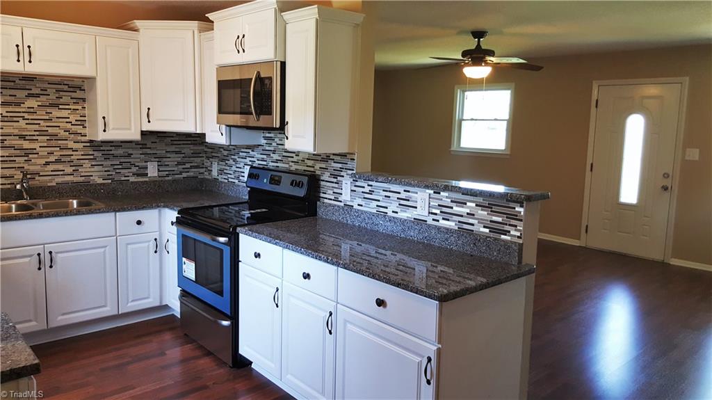 8131 East Harrell Road Oak Ridge, NC 27310 - Photo 5 of 13 Kitchen opens to living area and has space for bar seating!