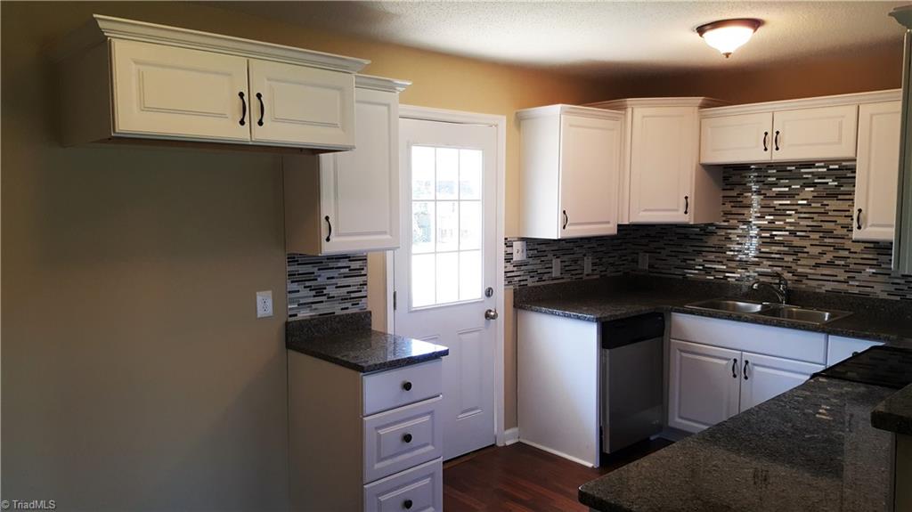 8131 East Harrell Road Oak Ridge, NC 27310 - Photo 6 of 13 Another view of the kitchen! Door leads to spacious, level backyard!