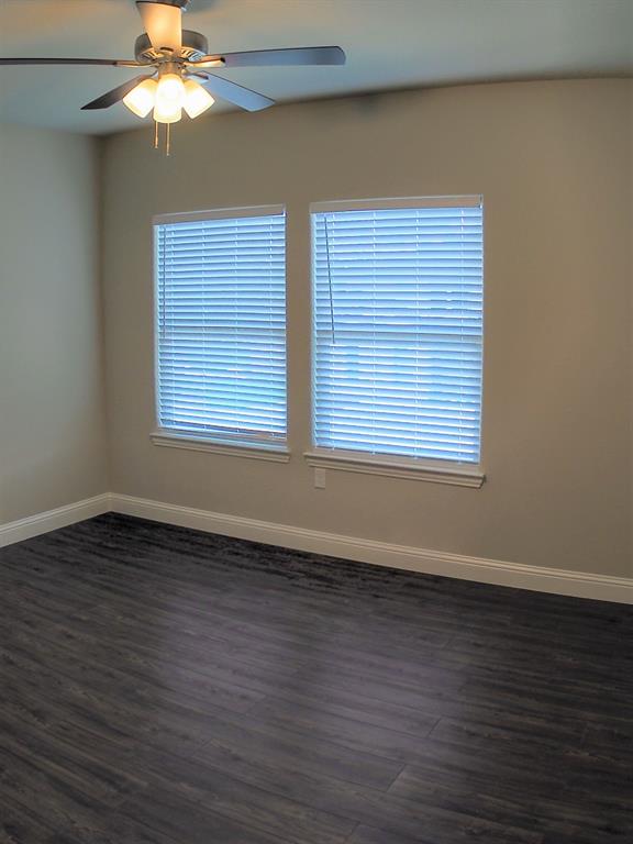 1601 Riney Road Denton, TX 76207 - Photo 12 of 18 an empty room with wooden floor fan and windows