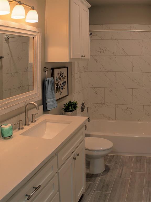 1601 Riney Road Denton, TX 76207 - Photo 13 of 18 a bathroom with a sink a toilet and shower