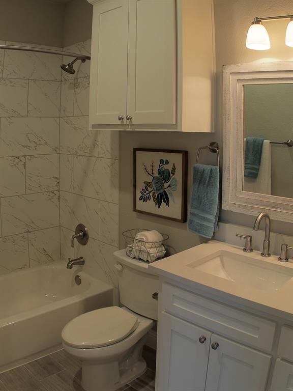 1601 Riney Road Denton, TX 76207 - Photo 18 of 18 a bathroom with a granite countertop toilet sink tub and mirror