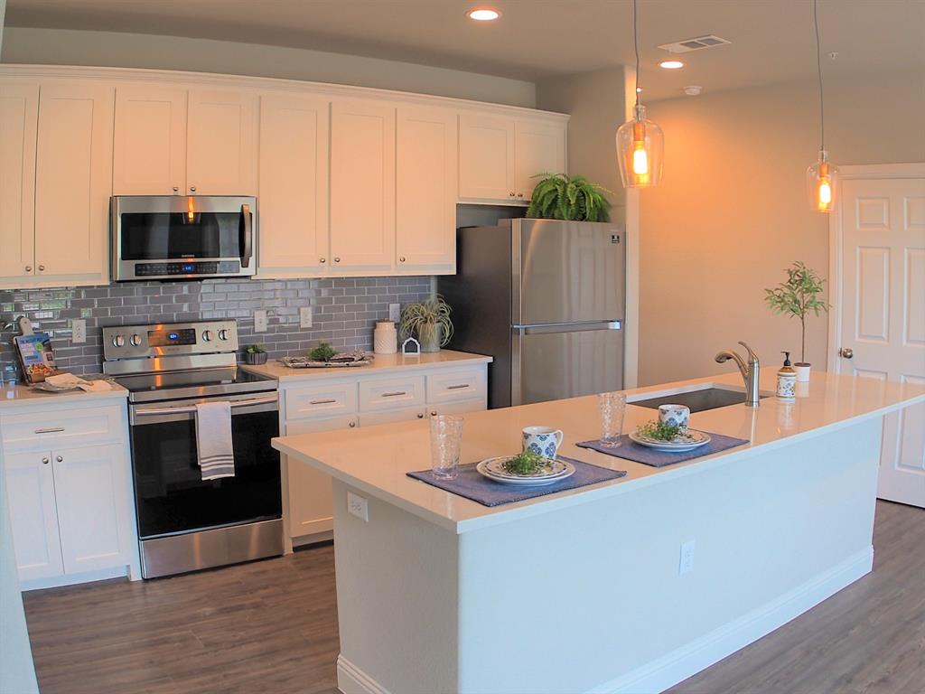 1601 Riney Road Denton, TX 76207 - Photo 5 of 18 a kitchen with stainless steel appliances granite countertop a sink a stove and a refrigerator