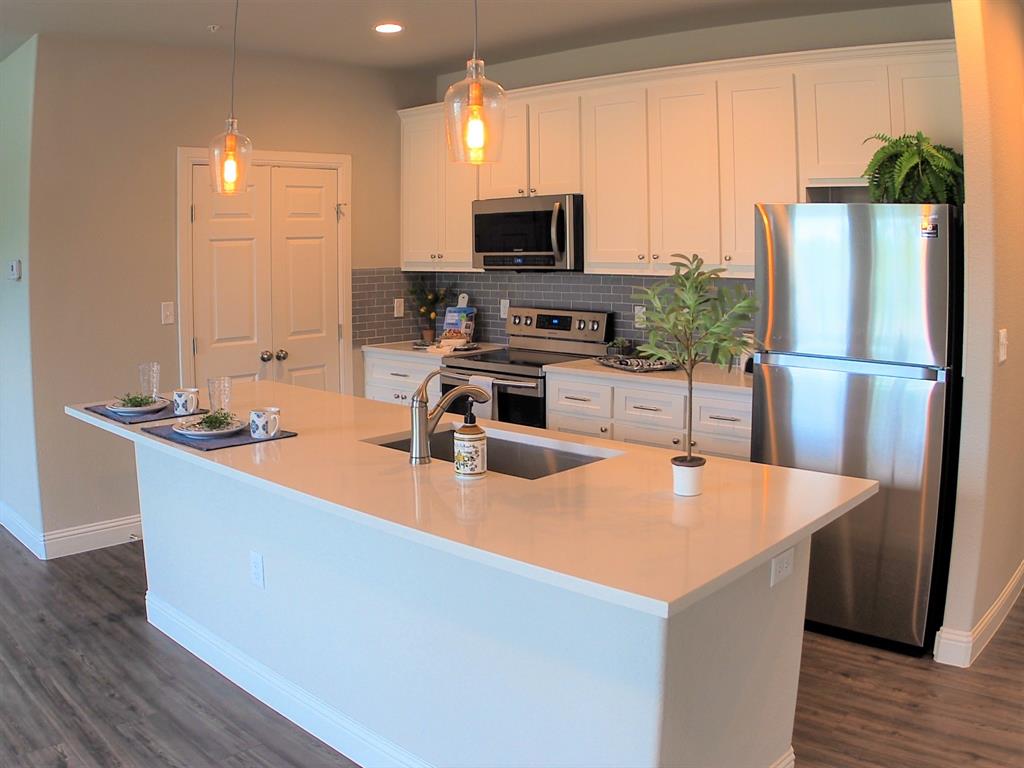 1601 Riney Road Denton, TX 76207 - Photo 6 of 18 a kitchen with stainless steel appliances granite countertop a refrigerator a stove top oven a sink and dishwasher