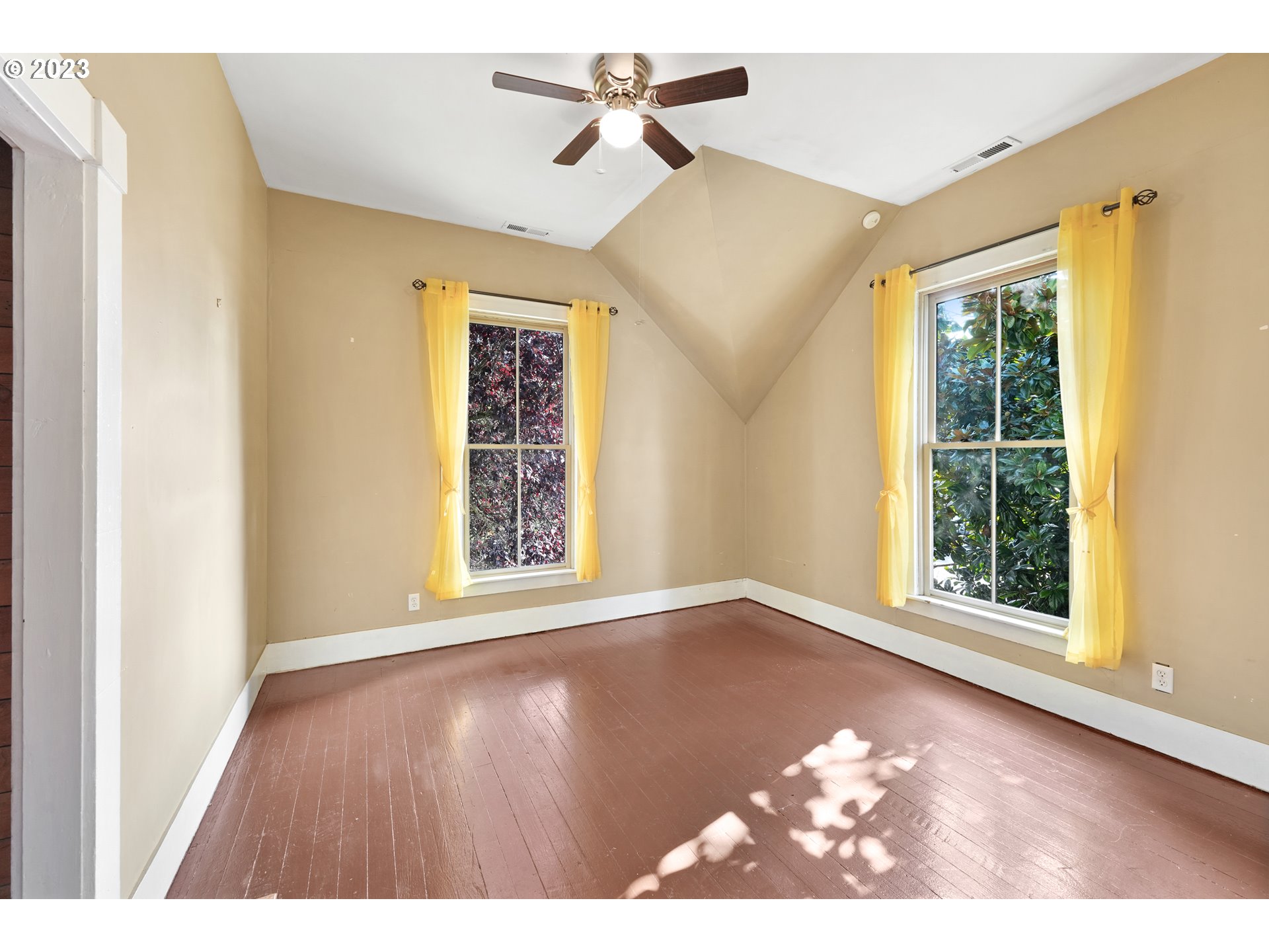 313 Centre Street La Conner, WA 98257 - Photo 24 of 29 a view of an empty room with a window and wooden floor