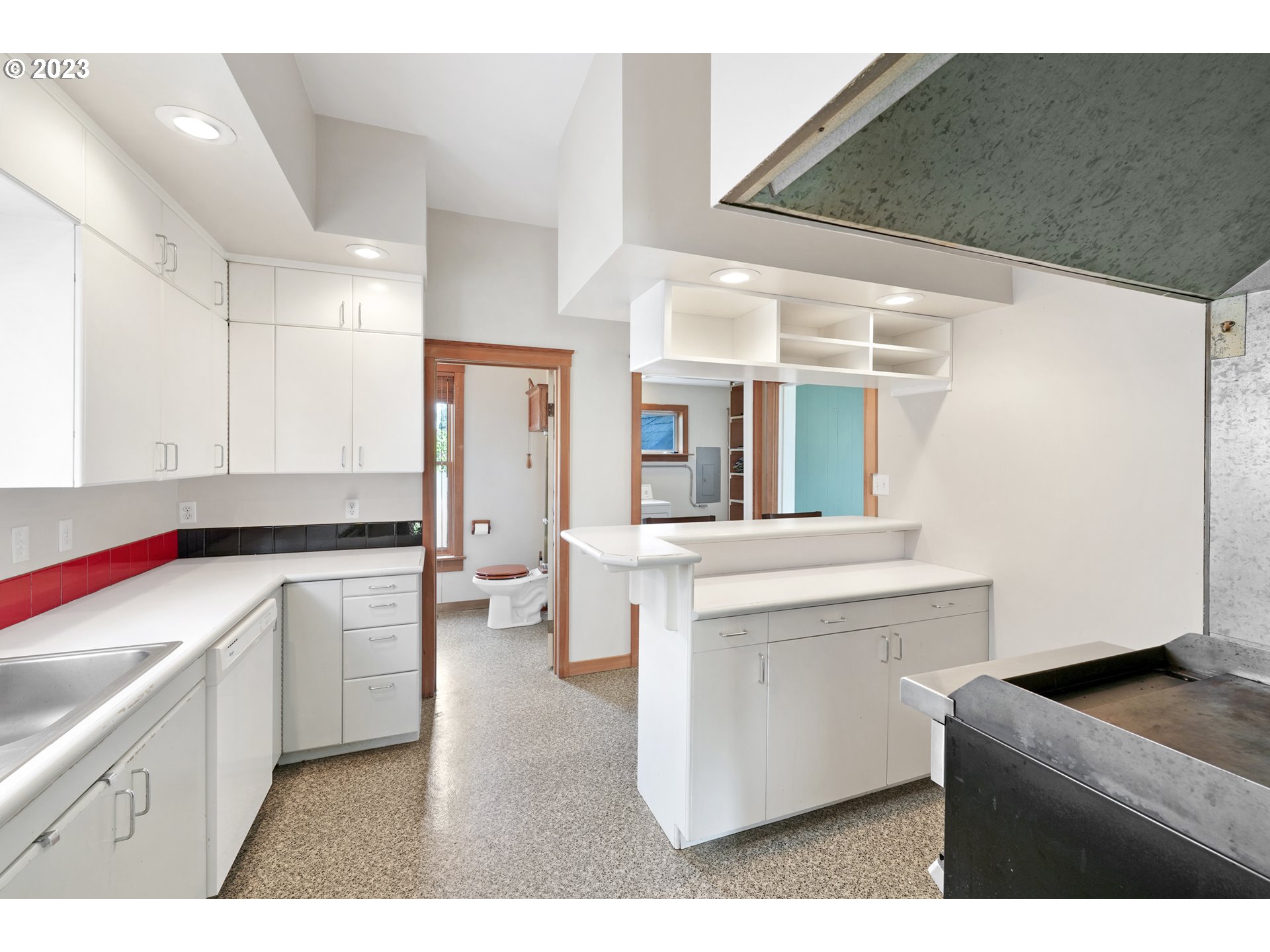 313 Centre Street La Conner, WA 98257 - Photo 3 of 29 a kitchen with a sink dishwasher stove and white cabinets