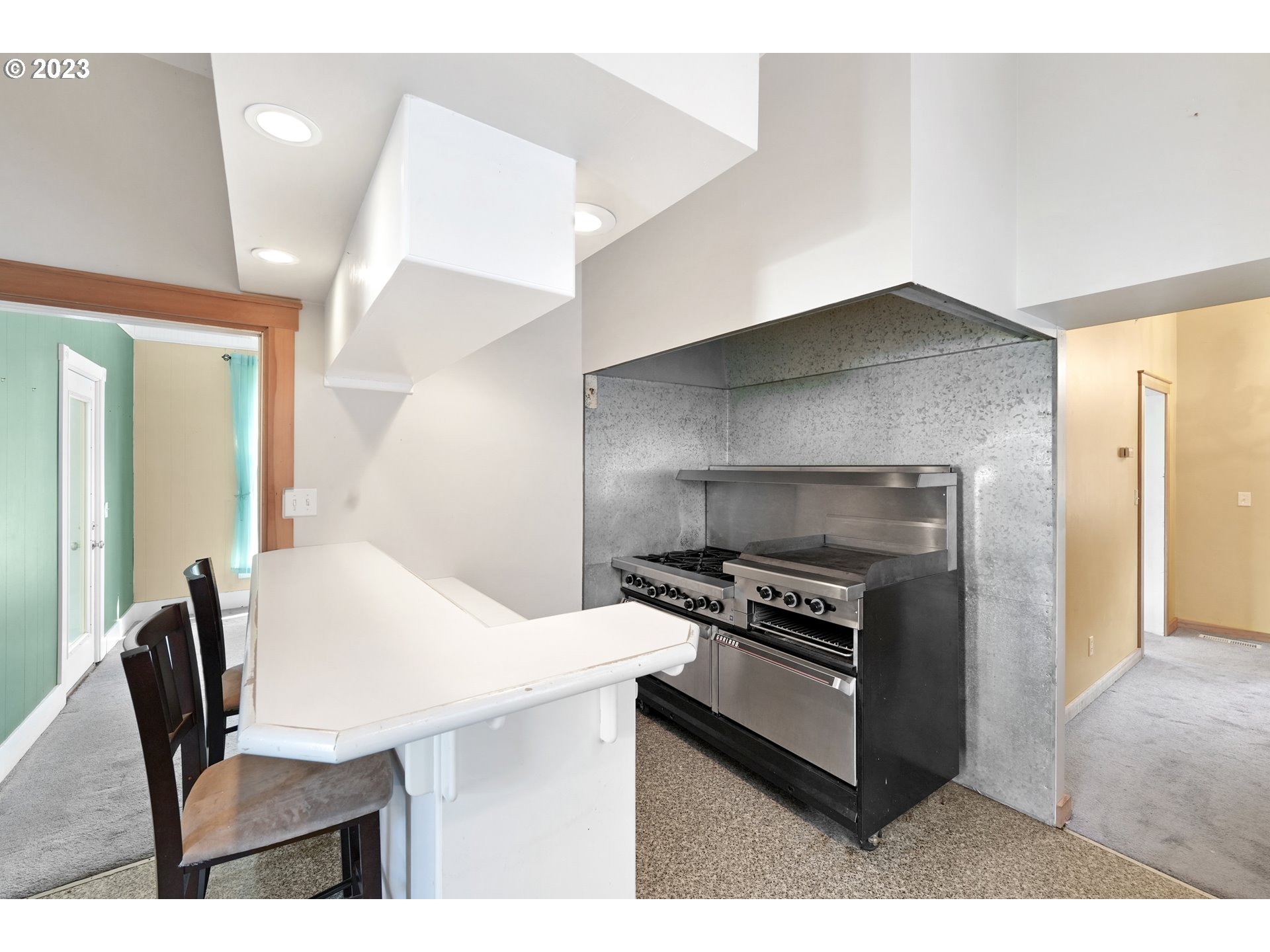 313 Centre Street La Conner, WA 98257 - Photo 4 of 29 a kitchen with a table chairs and a refrigerator