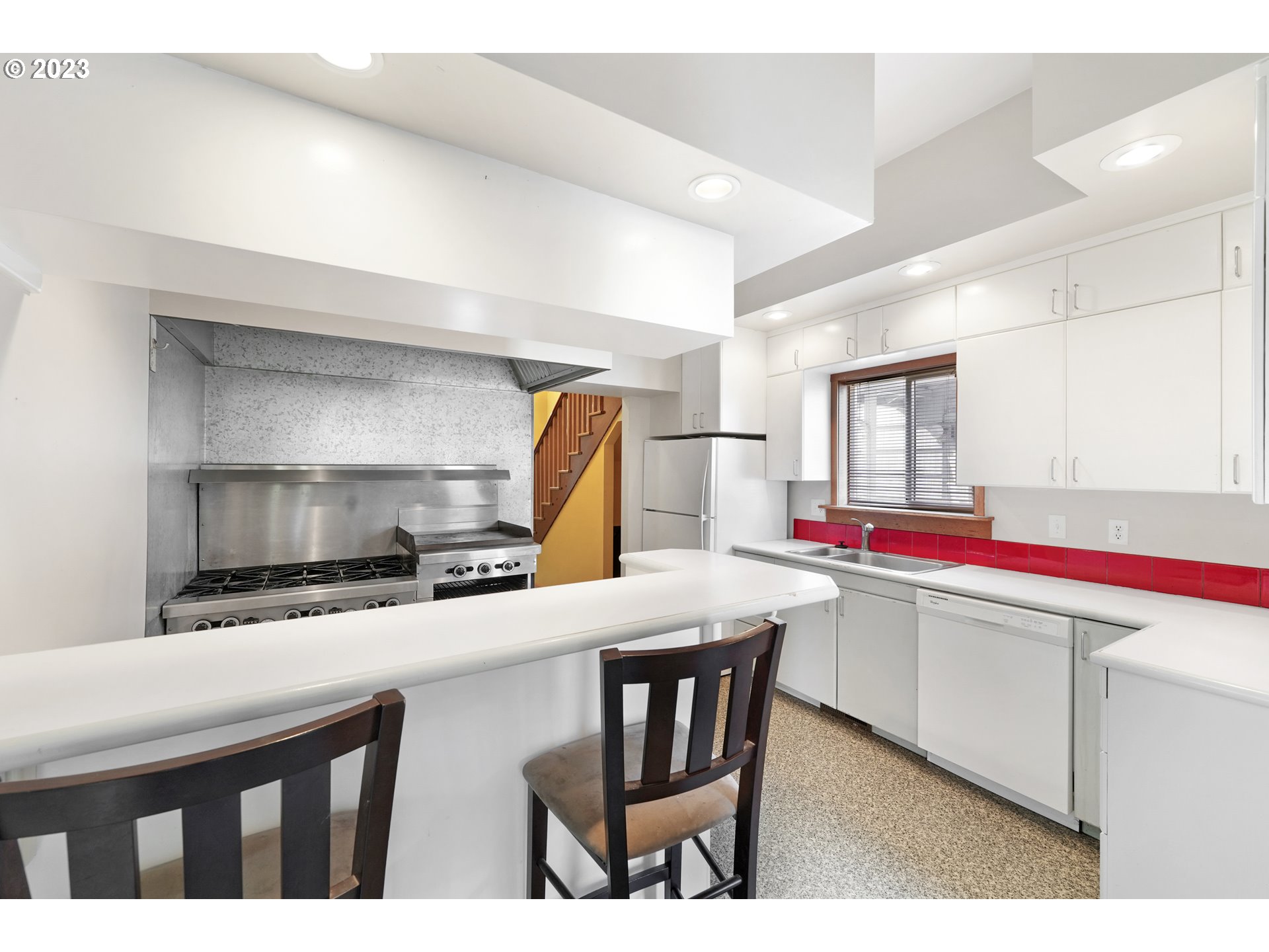 313 Centre Street La Conner, WA 98257 - Photo 5 of 29 a kitchen with a sink a stove and chairs
