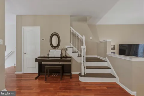 a view of a livingroom with wooden floor and a piano