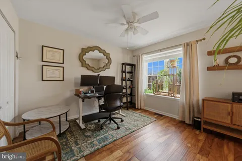 a workspace with furniture window and wooden floor