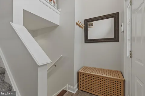 a view of hallway with stairs and wooden floor