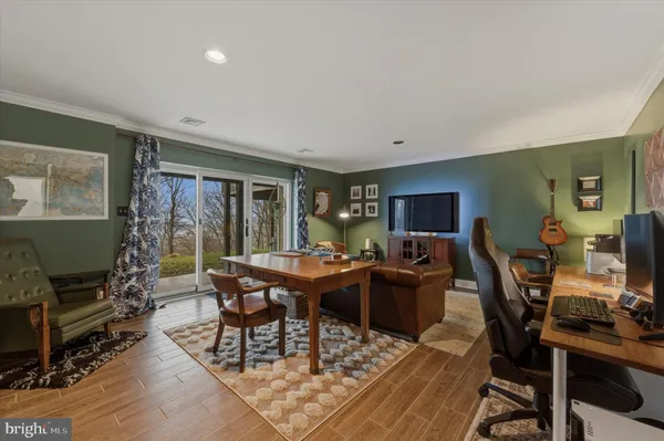 a view of a livingroom with furniture and a flat screen tv