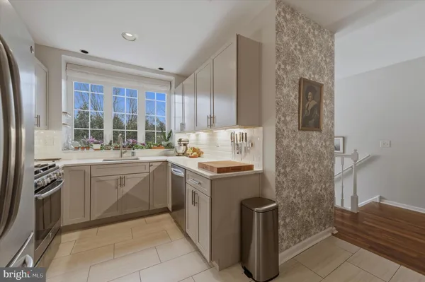 a kitchen with a stove sink and cabinets