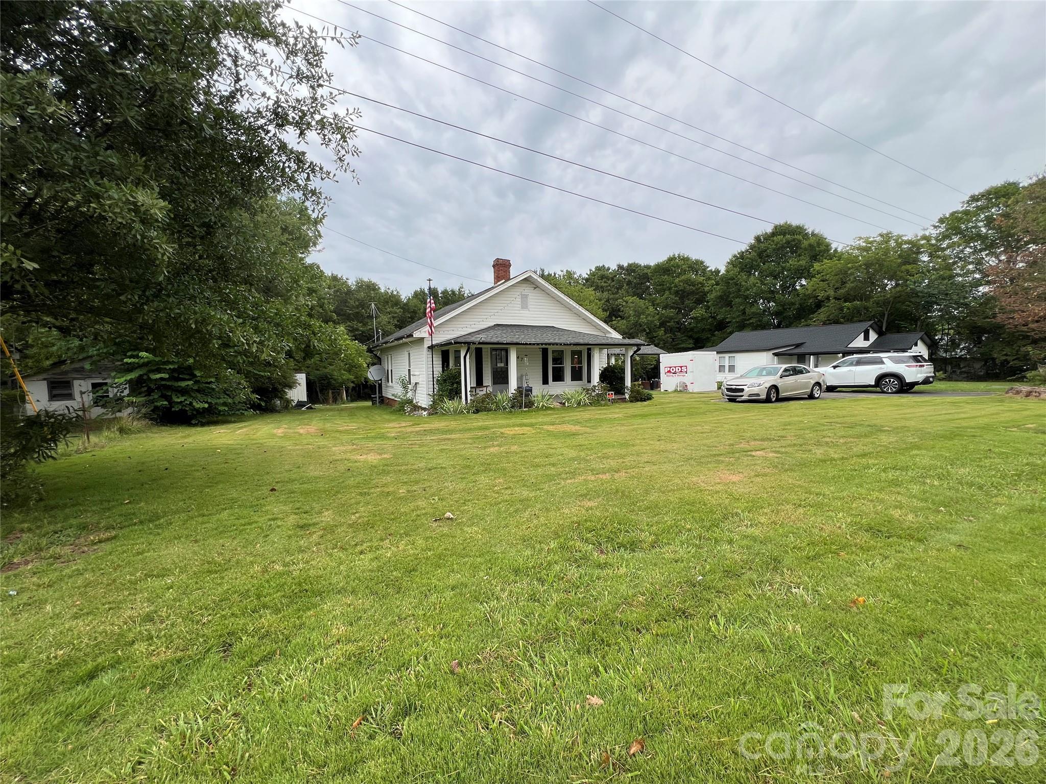473 Boss Moore Road Ellenboro, NC 28040 - Photo 5 of 29 a view of a swimming pool with lawn chairs and large trees