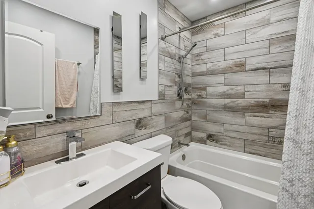 a bathroom with a sink vanity mirror and toilet