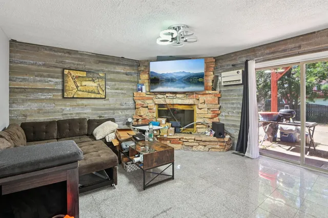 a living room with furniture a flat screen tv and a fireplace