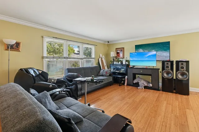 a living room with furniture a fireplace and a flat screen tv
