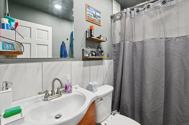 a bathroom with a sink toilet and shower