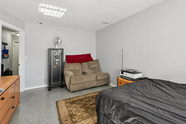 a bedroom with bed and window