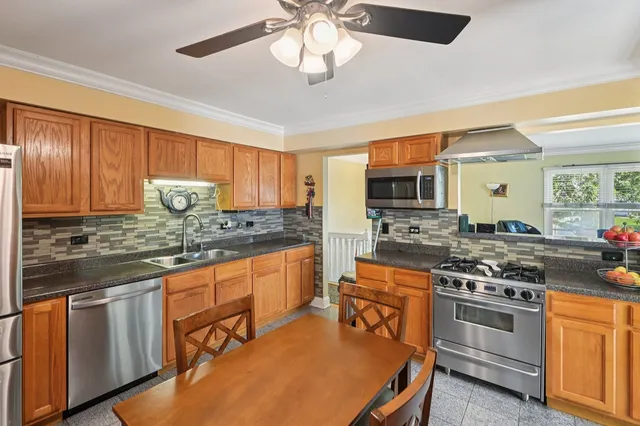 a kitchen with stainless steel appliances a stove sink microwave and cabinets