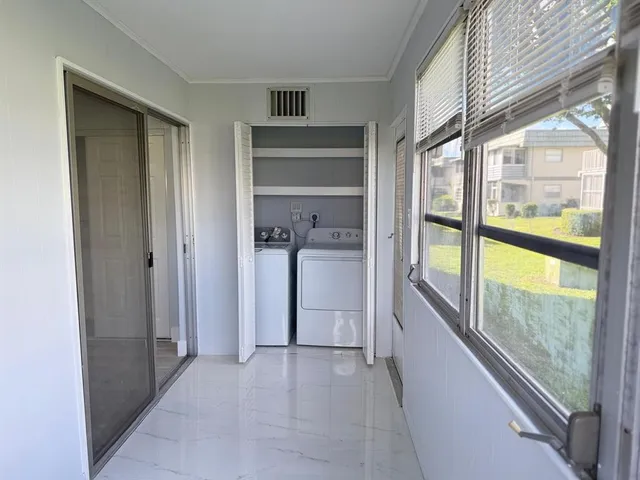 a view of an empty room and a window