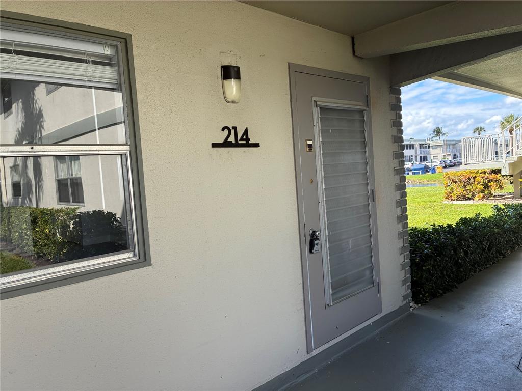 214 Monaco Boulevard, Unit 214 Delray Beach, FL 33446 - Photo 20 of 22 a view of a door and wooden floor in a room