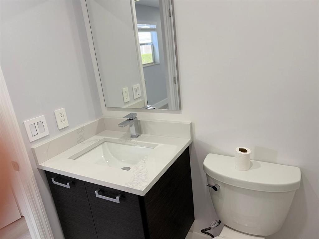 214 Monaco Boulevard, Unit 214 Delray Beach, FL 33446 - Photo 7 of 22 a bathroom with a sink and a mirror