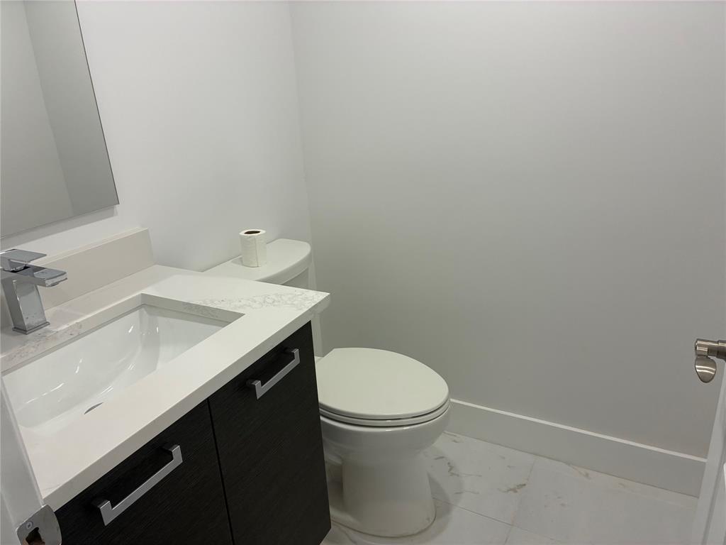 214 Monaco Boulevard, Unit 214 Delray Beach, FL 33446 - Photo 8 of 22 a bathroom with a sink and a toilet