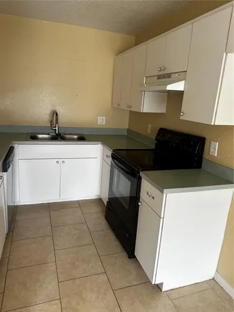 a kitchen with a cabinets and white appliances