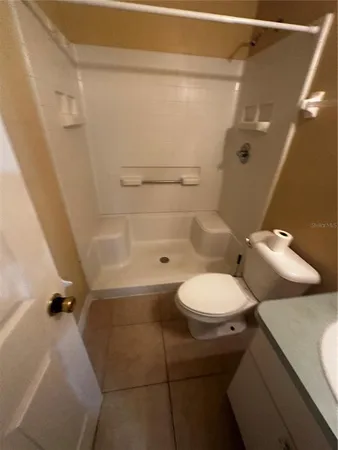 a bathroom with a toilet and a shower