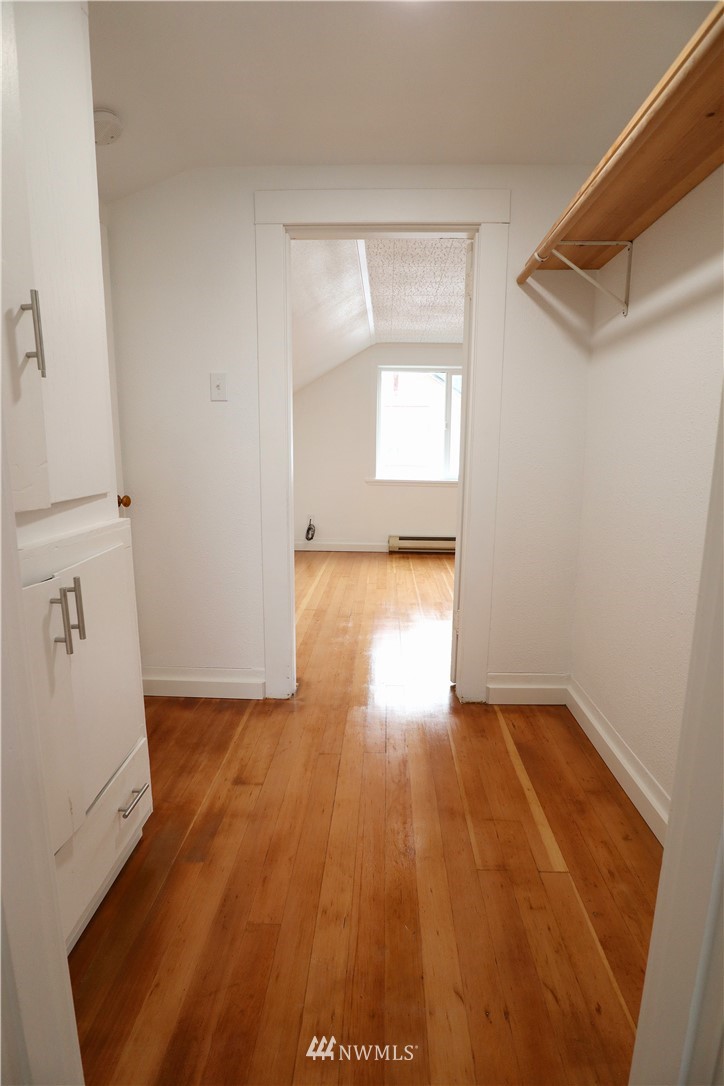 305 Fillmore Street Hoquiam, WA 98550 - Photo 16 of 23 an empty room with wooden floor and windows