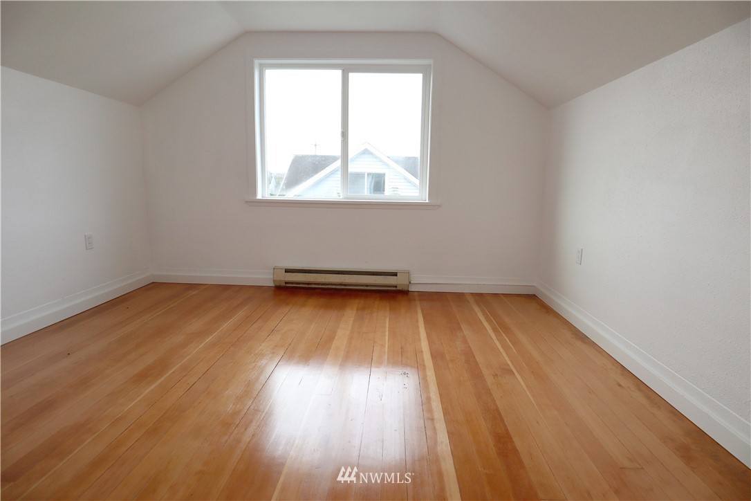 305 Fillmore Street Hoquiam, WA 98550 - Photo 18 of 23 an empty room with wooden floor and windows