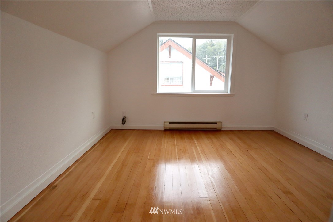 305 Fillmore Street Hoquiam, WA 98550 - Photo 19 of 23 an empty room with wooden floor and windows