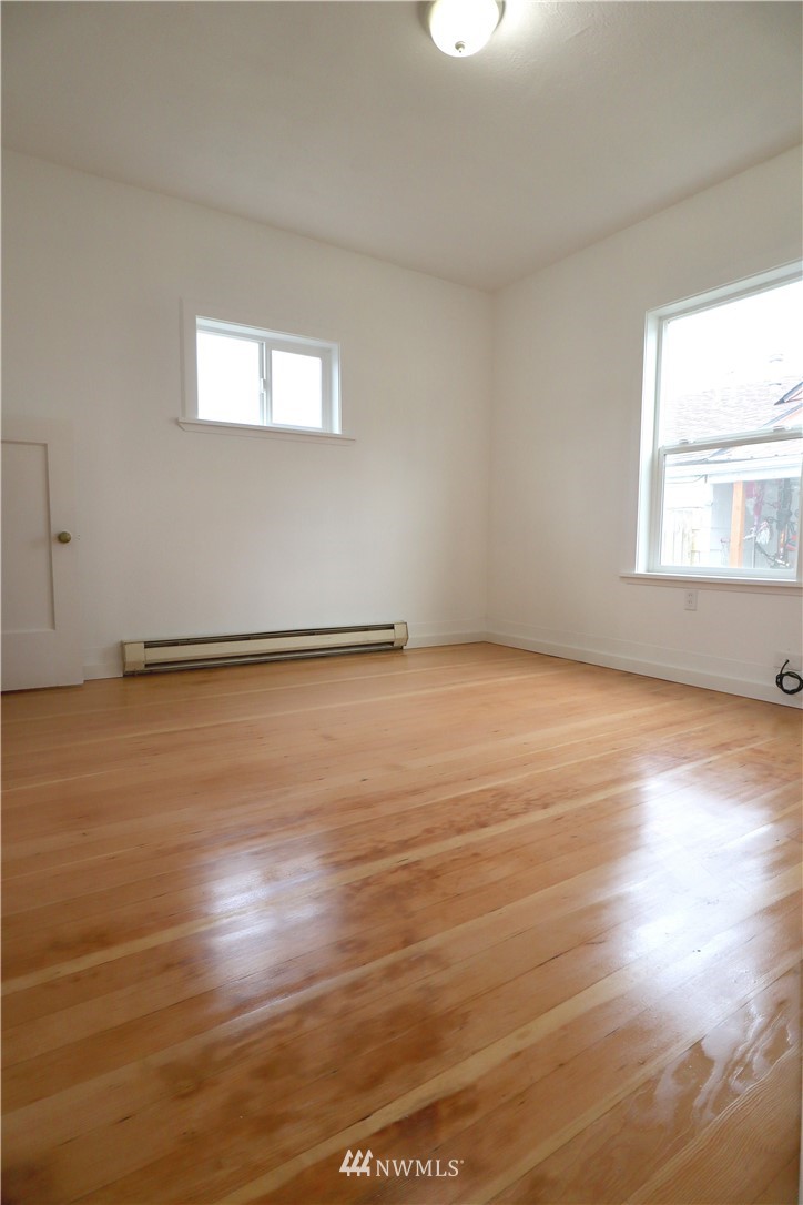 305 Fillmore Street Hoquiam, WA 98550 - Photo 20 of 23 an empty room with wooden floor and windows