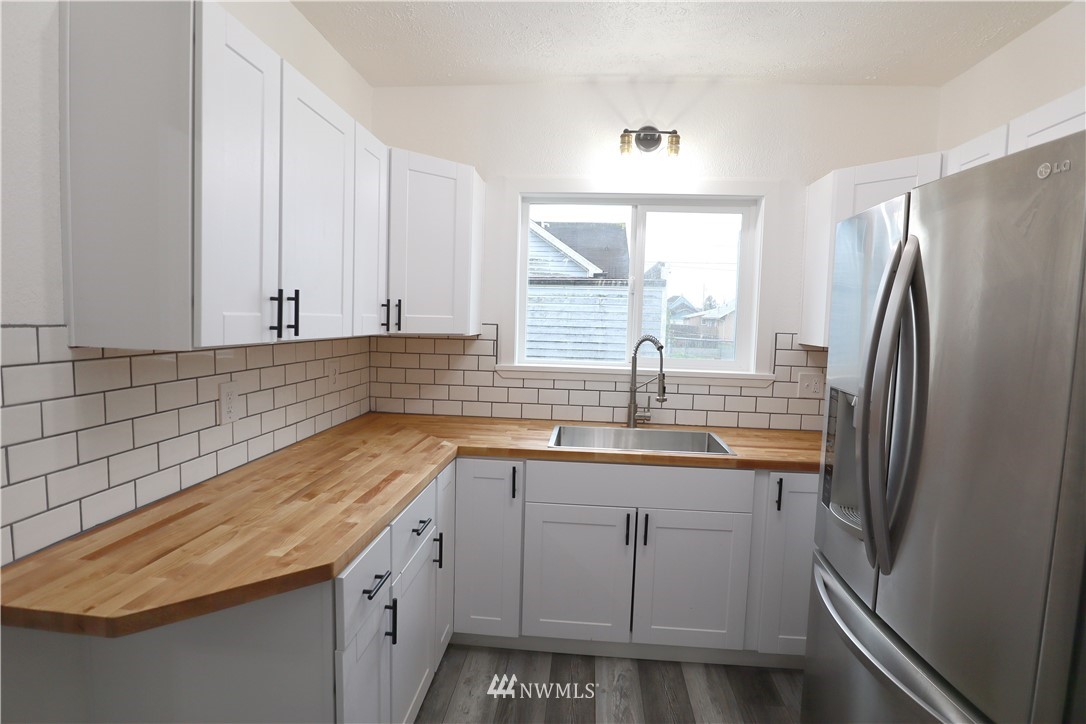 305 Fillmore Street Hoquiam, WA 98550 - Photo 6 of 23 a kitchen with a sink appliances and cabinets